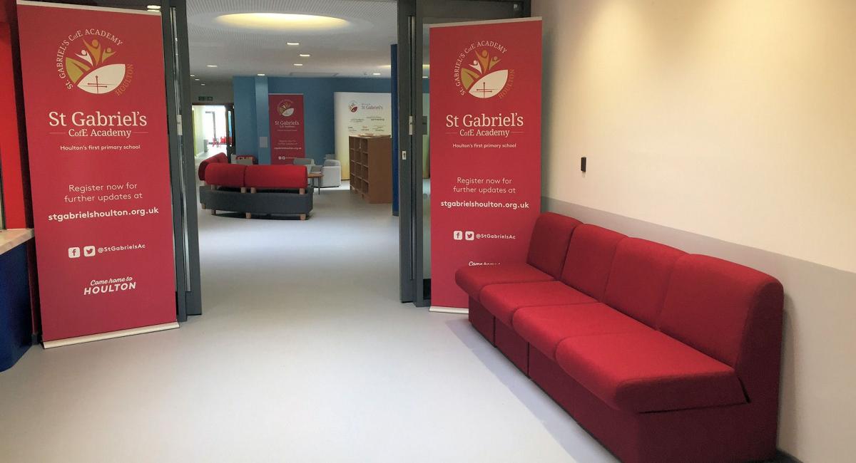 School welcome area, with red soft bench seating area