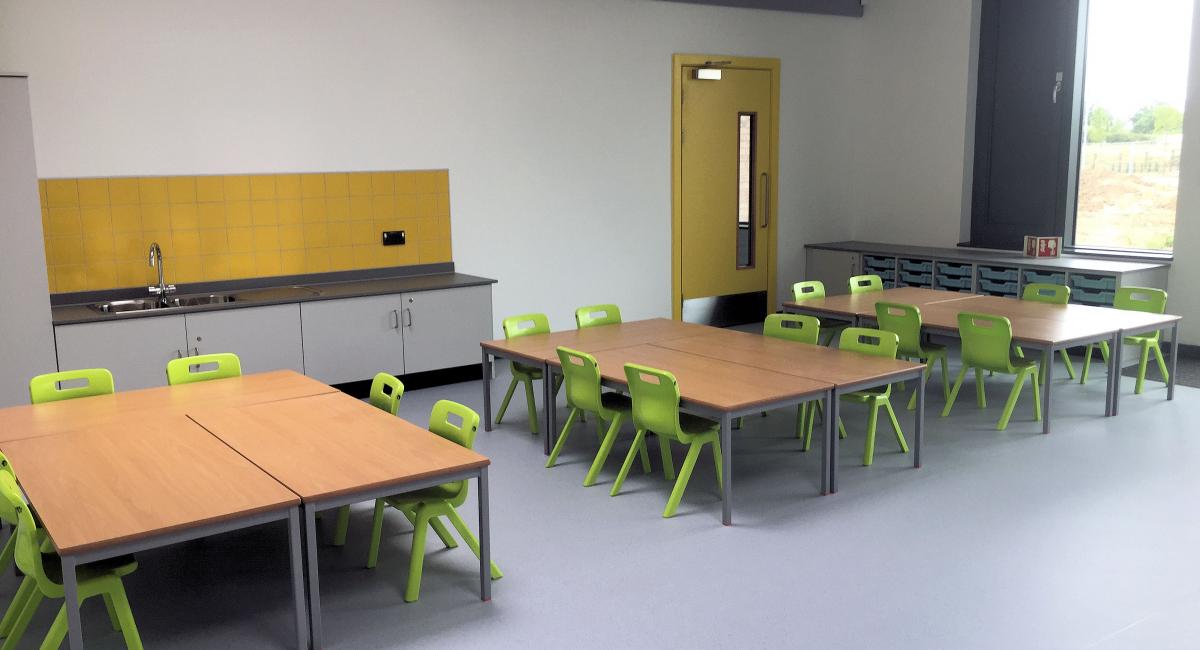 Classroom fully welded tables and one piece Postura+ classroom chairs finished in lime green.